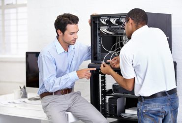 Never fear when the IT guy is near. A young IT specialist ready A young IT specialist ready to fix a server.